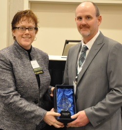 Mickey Dietrich accepting the 2015 GIS Champion award on behalf of Tim Turck, the Superintendent of Public Works for the Village of West Carthage.